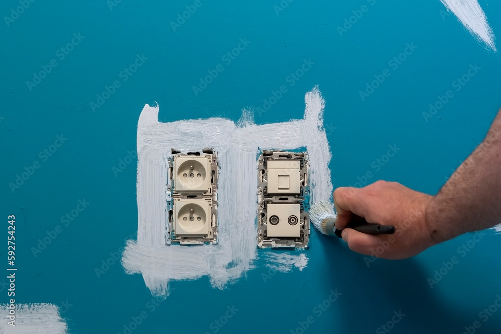 Wall painting around electrical outlets. removed power socket frame for