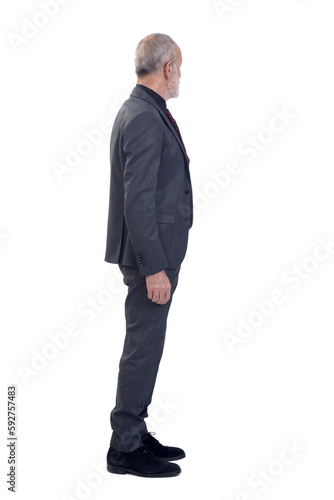 side view of a man standing with suit and tie and  look at the bottom on white background