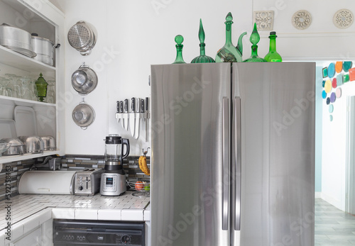White stylish kitchen interior with modern steel refrigerator.