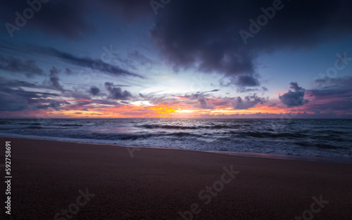 sunrise with dramatic clouds on the beach