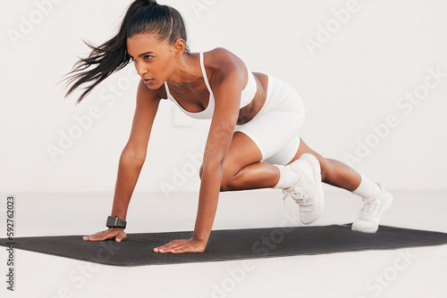 Картината върху платно Fit female in white fitness attire doing core exercises on a mat