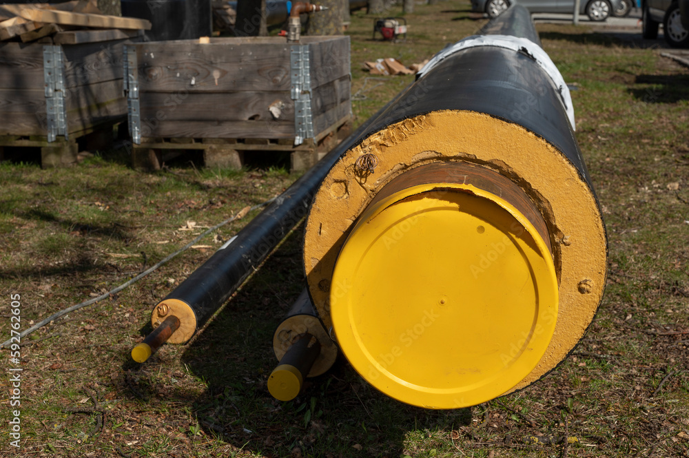 the yellow end of a district heating pipe lying on the ground