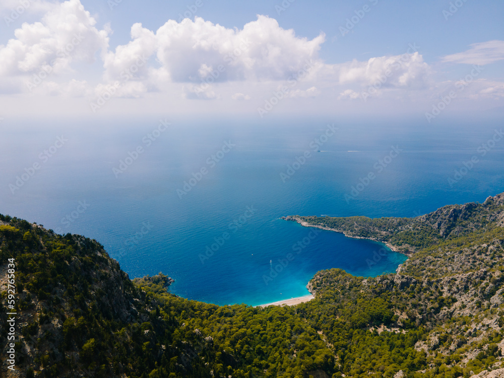 Aerial drone shot of Balartı or Paradise Bay, located on the Lycian Way in Fethiye district of Muğla, Turkey. Photo shows the mountains, trees, a secluded bay and the turquoise waters of Mediterranean