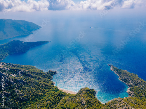 Aerial drone shot of Balartı or Paradise Bay, located on the Lycian Way in Fethiye district of Muğla, Turkey. Photo shows the mountains, trees, a secluded bay and the turquoise waters of Mediterranean