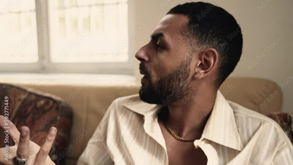 Dramatic couple discussing problems at home. A young man and woman discussing relationship troubles. Male person brooding over female stress Dramatic couple discussing problems at home. A young man and woman discussing relationship troubles. Male person brooding over female stress