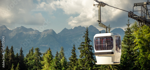 gondola ski lift in mountain ski resort, green forest © nickolya