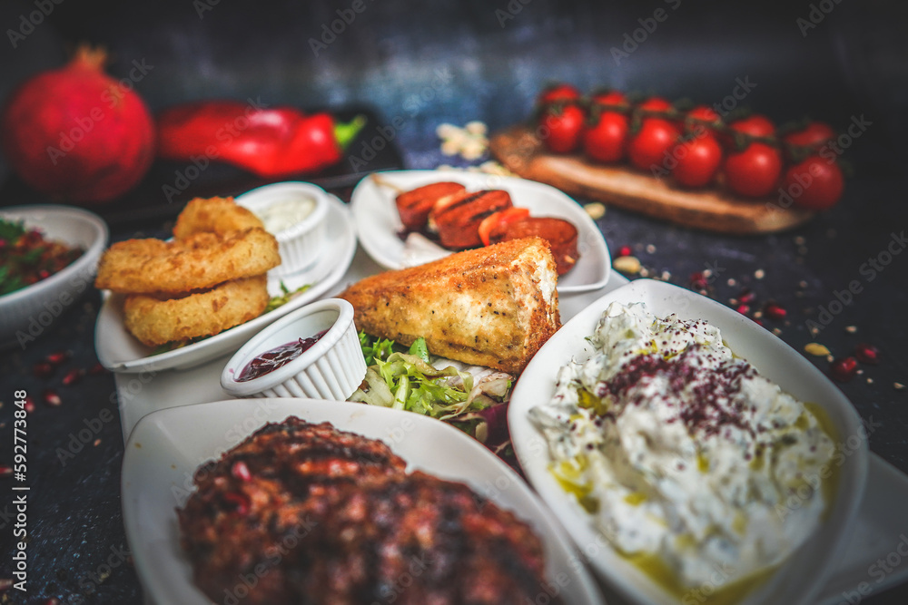 Close-Up of Hot and Cold Mezze Platter: Assorted Appetizers, Mediterranean Cuisine, Flavorful Dishes, Gourmet Food, Tasty Variety, Social Dining Experience