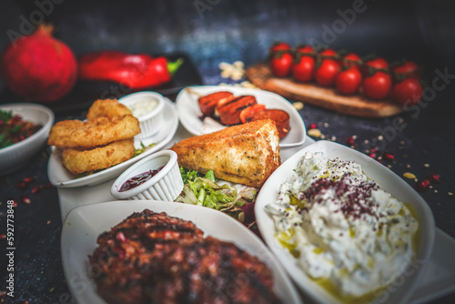 Close-Up of Hot and Cold Mezze Platter: Assorted Appetizers, Mediterranean Cuisine, Flavorful Dishes, Gourmet Food, Tasty Variety, Social Dining Experience