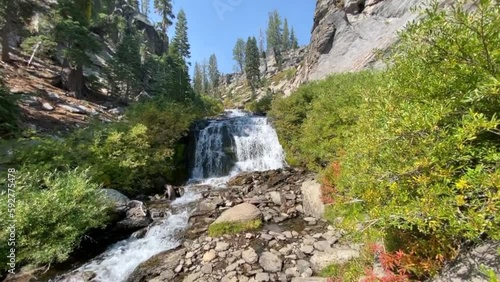 Kings Creek Falls in Lassen Volcanic National Park in northern California. Alpine cascade in a pine forest, steep cliffs and vegetation surround the area. Pre Dixie Fire.  photo