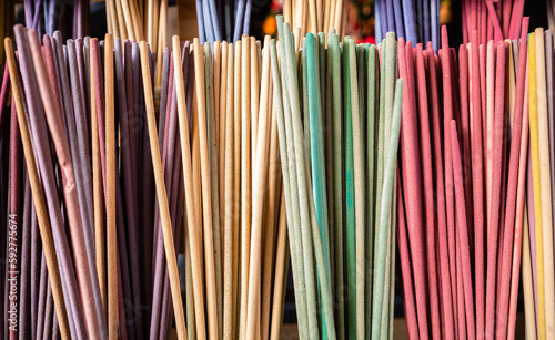 A close-up of a multi colored and aromatic sticks, forming a vibrant decoration without any people in the background.