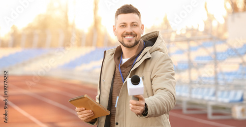 Male reporter with micropho...