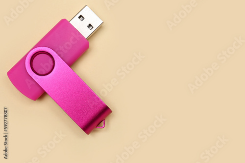 Pink USB flash drive on yellow background