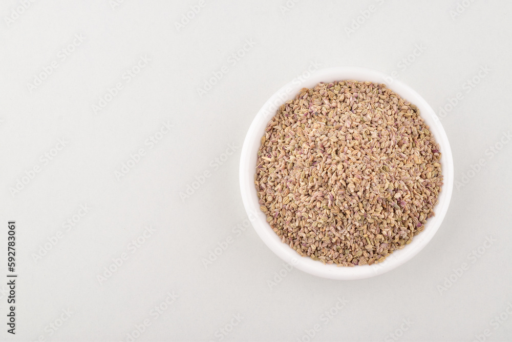 Top view of ajwain seeds in bowl on white background Top view of ajwain seeds in bowl on white background