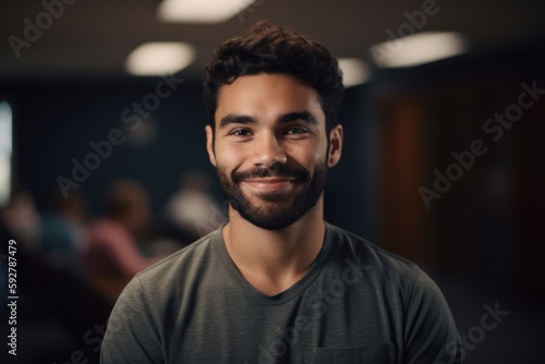 Portrait of a young man smiling while standing in a conference room