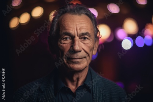 Portrait of an elderly man in a nightclub, looking at the camera.