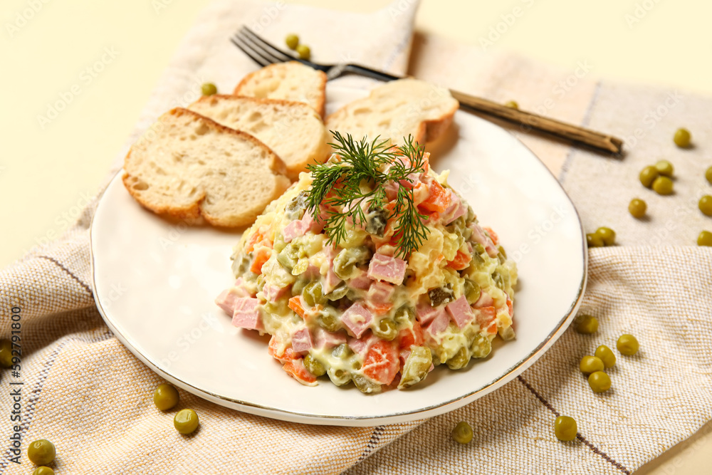 Plate of tasty Olivier salad on yellow background Plate of tasty Olivier salad on yellow background
