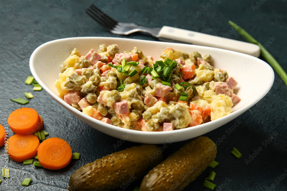 Bowl of tasty Olivier salad on dark background Bowl of tasty Olivier salad on dark background