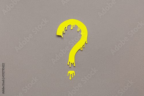 Paper question mark on dark...