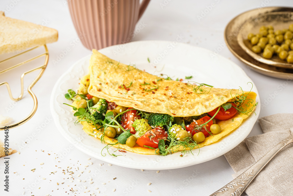 Tasty omelet with vegetables on light background Tasty omelet with vegetables on light background
