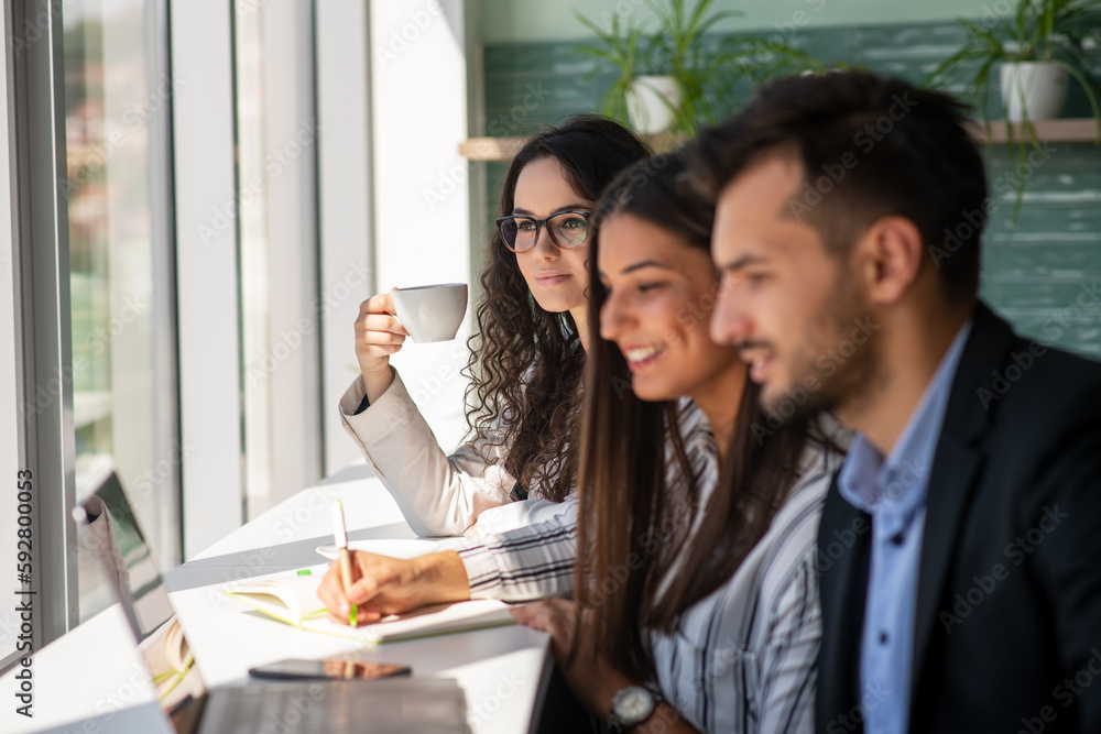 Creative business team sharing laptop in office, watching startup presentation, brainstorming, pointing at monitor, talking. Creative business team sharing laptop in office, watching startup presentation, brainstorming, pointing at monitor, talking.