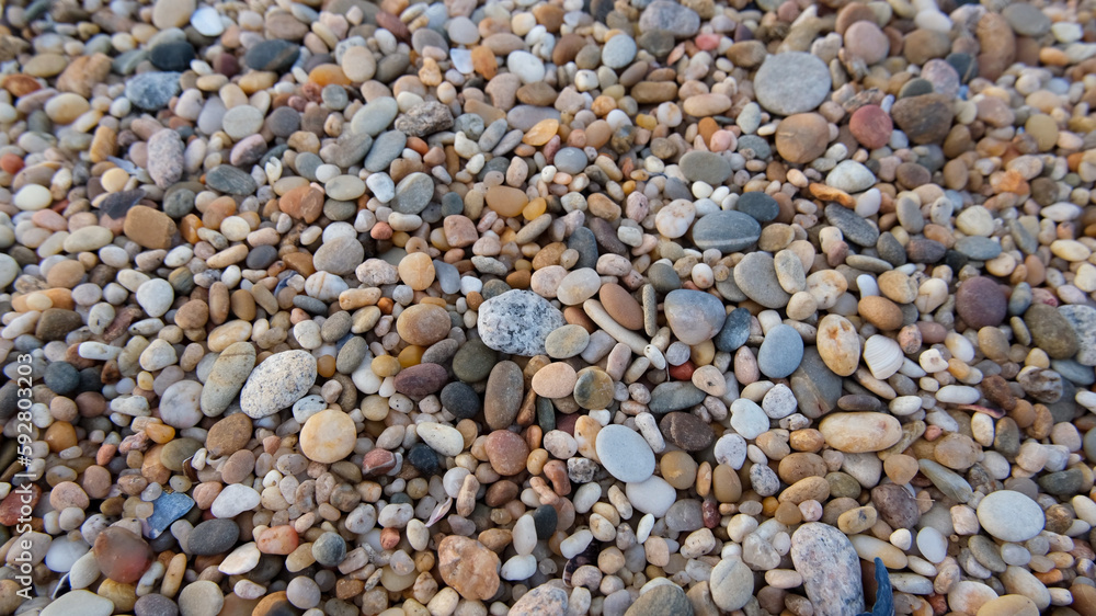 Smooth round pebbles on beach in Portugal. Natural background texture. Smooth round pebbles on beach in Portugal. Natural background texture.