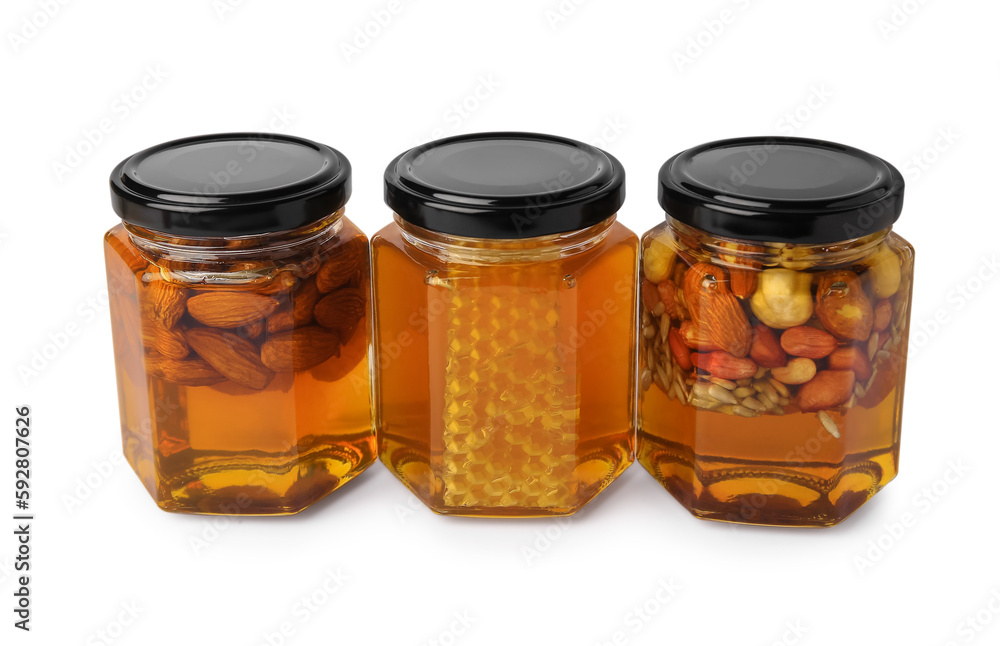 Jars with different nuts and honey on white background Jars with different nuts and honey on white background