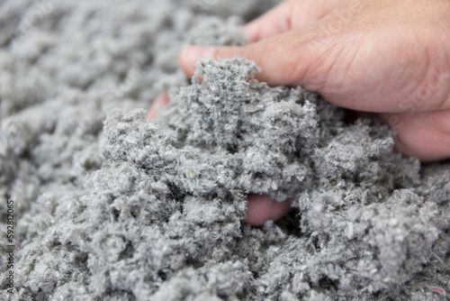 Hand Grasping Sustainable Cellulose Insulation