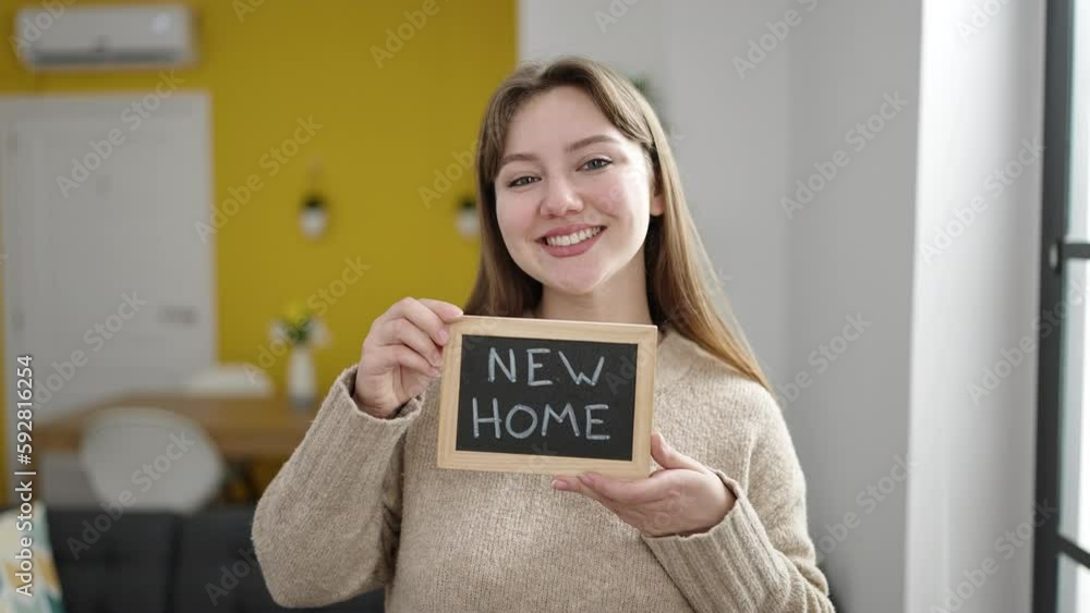 Young blonde woman smiling confident holding new home blackboard at home Young blonde woman smiling confident holding new home blackboard at home