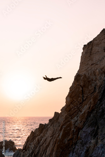 silueta de clavado desde la quebrada, acapulco, guerreo, mexico photo