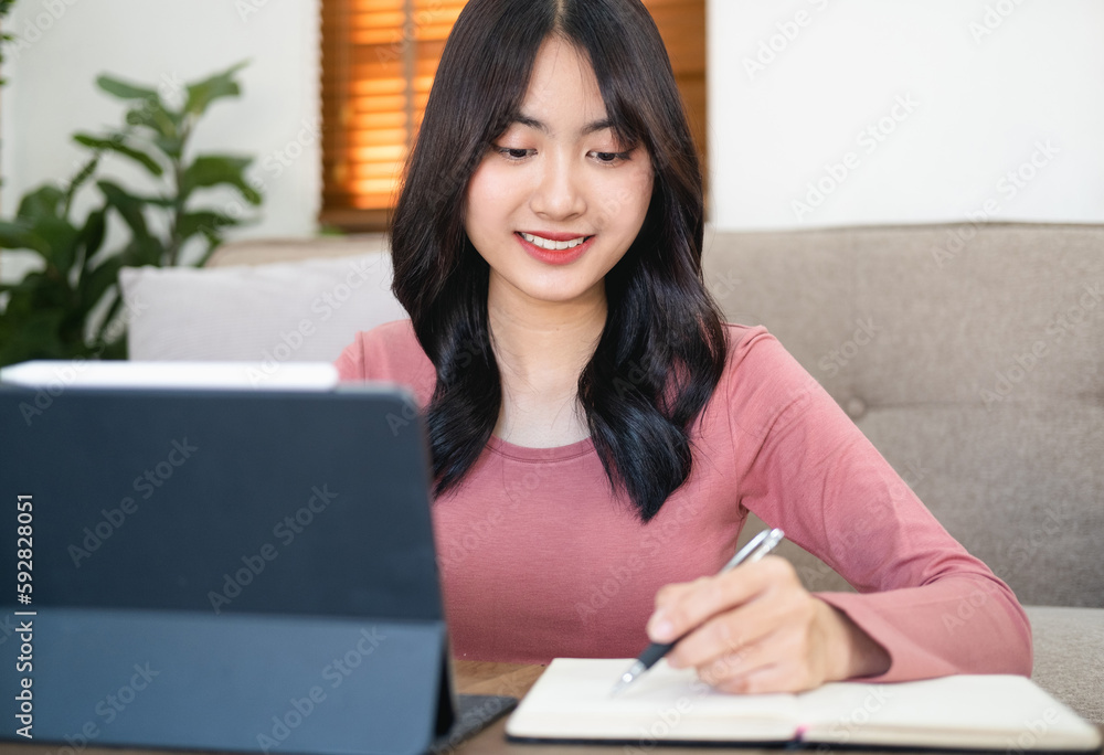 Asian woman in online learning , watching educational webinar on laptop. Young businesswoman holding video call with clients partners.Young female student study in home. Asian woman in online learning , watching educational webinar on laptop. Young businesswoman holding video call with clients partners.Young female student study in home.