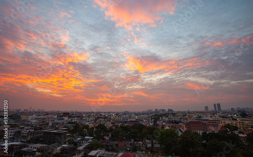 .The colorful sky over Bangkok city center in the evening..amazing red sky at sunset..Temples and buildings in Bangkok background..