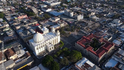Beautiful cinematic aerial footage of the city of San Salvador, its Metropolitan Cathedral, Plaza, and the National Palace of El Salvador photo