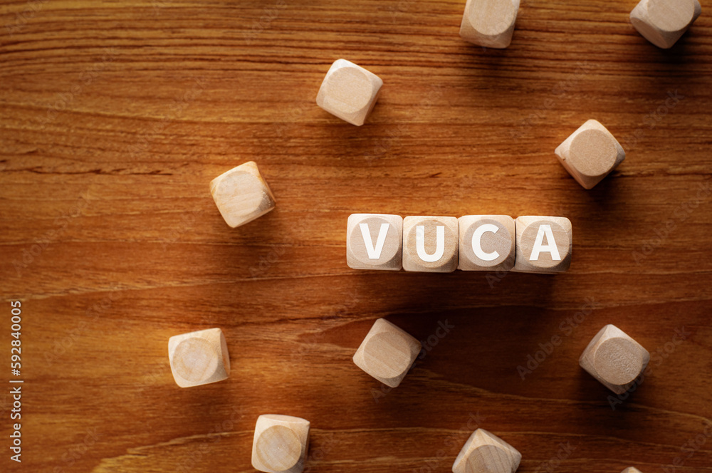 There is wood cubes with the word VUCA. It is an abbreviation for Volatility, Uncertainty, Complexity, Ambiguity as eye-catching image. There is wood cubes with the word VUCA. It is an abbreviation for Volatility, Uncertainty, Complexity, Ambiguity as eye-catching image.