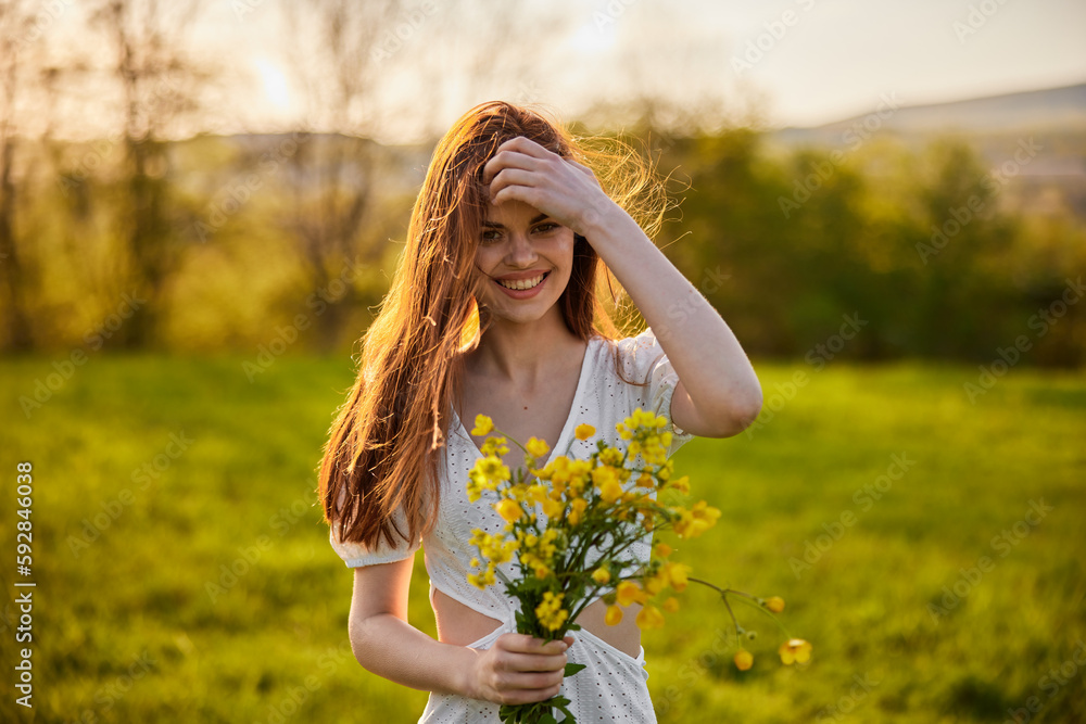 the woman is depicted in the countryside with a bouquet of yellow flowers the woman is depicted in the countryside with a bouquet of yellow flowers