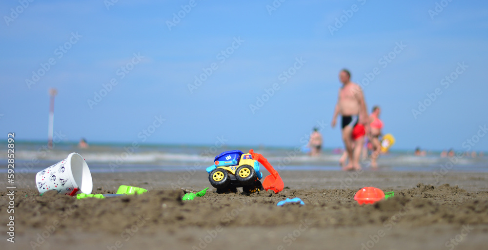 Fototapeta premium children's games on the sand in front of the sea