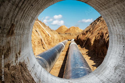 Insulated pipe. Large metal pipes with a plastic sheath laid in a trench. Modern pipeline for supplying hot water and heating to a residential area.
