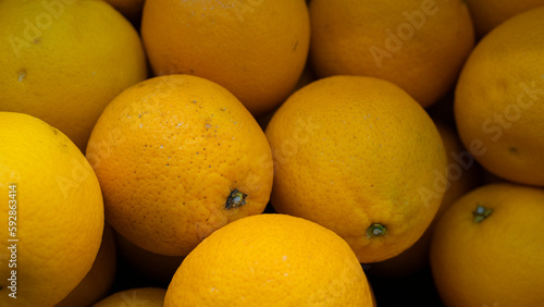 A cheerful gathering of zesty lemons, brimming with tangy flavors and invigorating aromas, nestled in a market basket.