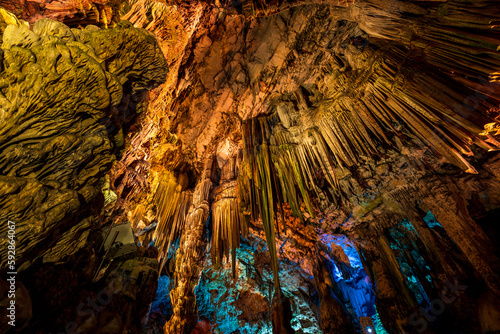 Illuminated natural underground rock formations inside St. Michaels cave in Gibraltar, UK