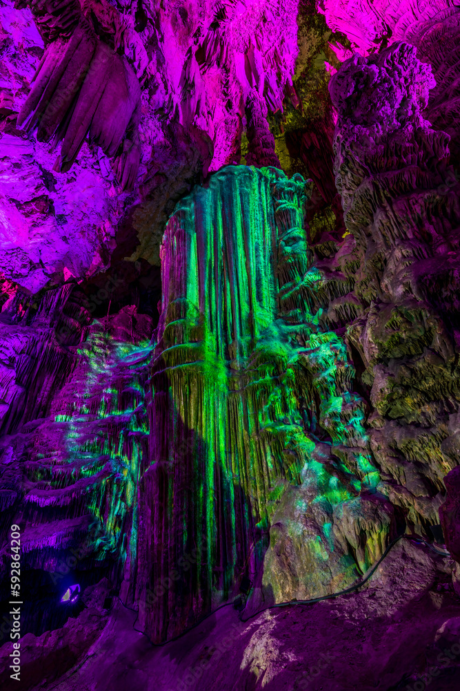 Illuminated natural underground rock formations inside St. Michaels cave in Gibraltar, UK