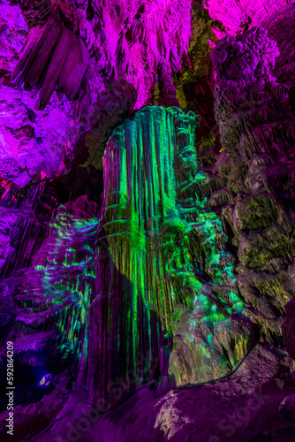 Illuminated natural underground rock formations inside St. Michaels cave in Gibraltar  UK