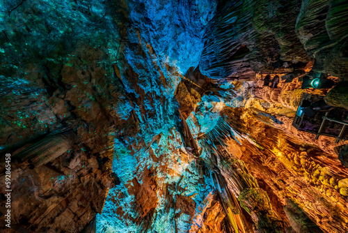 Illuminated natural underground rock formations inside St. Michaels cave in Gibraltar, UK