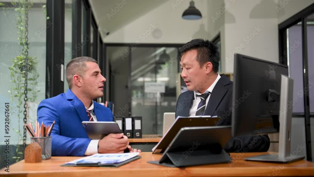 Kind leader executive manager share and discuss business solutions plan ideas on tablet with male marketing manager in office. Kind leader executive manager share and discuss business solutions plan ideas on tablet with male marketing manager in office.