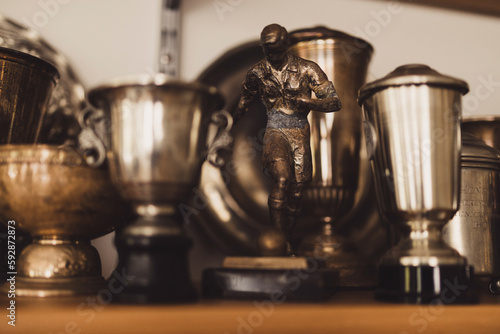 Soccer trophies on a shelf.

