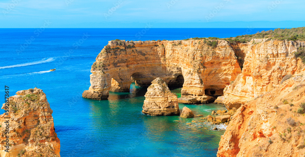 Aerial view of majestic rock formation,  coast of the Algarve- Tourism,  travel,  vacation in Europe (natural cave or arch on praia da marinha)