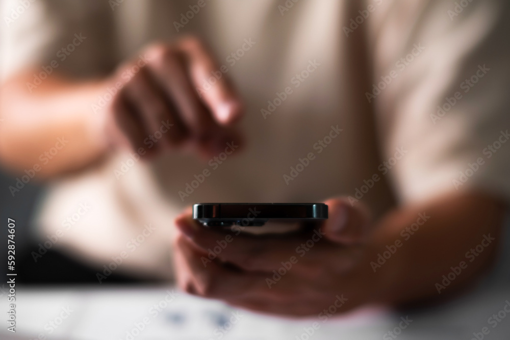 Fototapeta premium Close up of man hand pointing on smart phone. technology concept