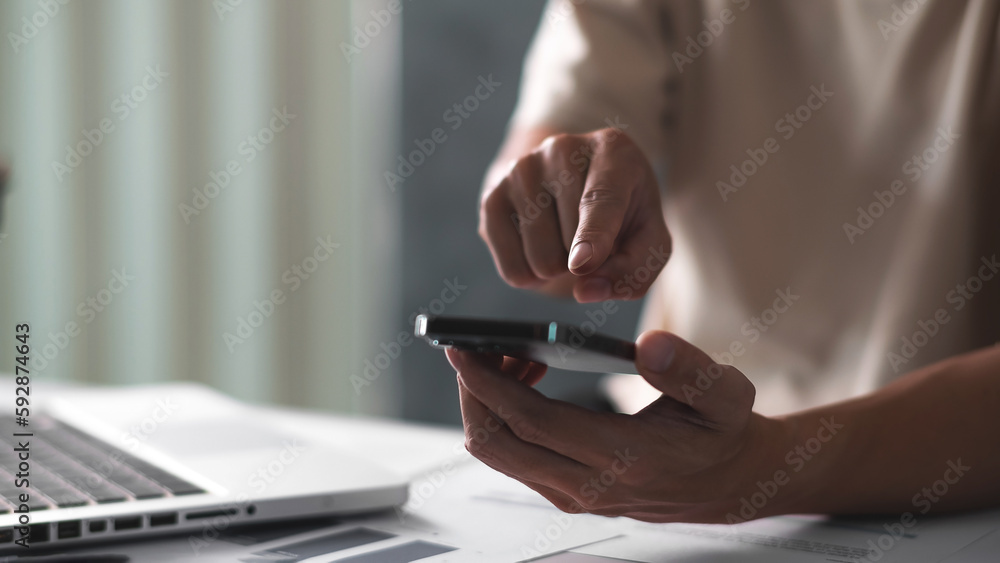 Close up of man hand pointing on smart phone. technology concept Close up of man hand pointing on smart phone. technology concept