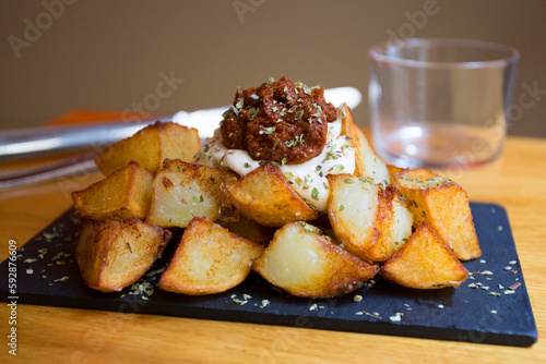 Papas bravas, are a typical preparation of bars in Spain consisting of potatoes cut into large cubes, fried in olive oil and seasoned with salsa brava, which is a spicy sauce.