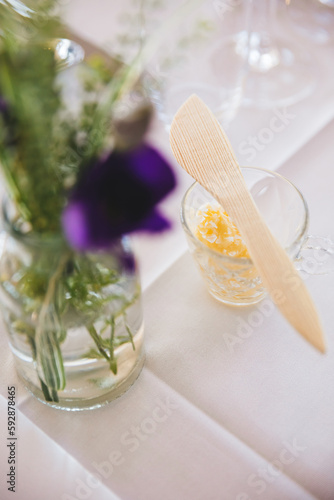 A cup of butter with salt flakes on top.