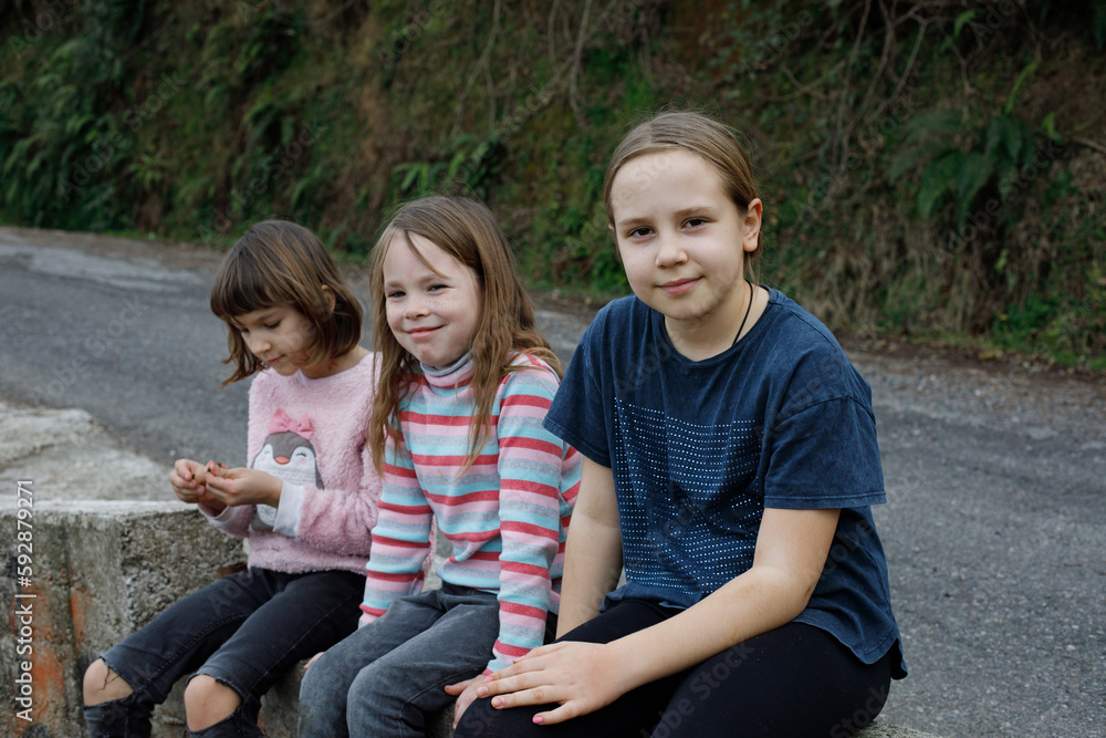 Cute children little girls portrait. Kid sitting outdoor Cute children little girls portrait. Kid sitting outdoor