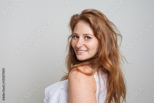 Happy model woman looking at camera on white background